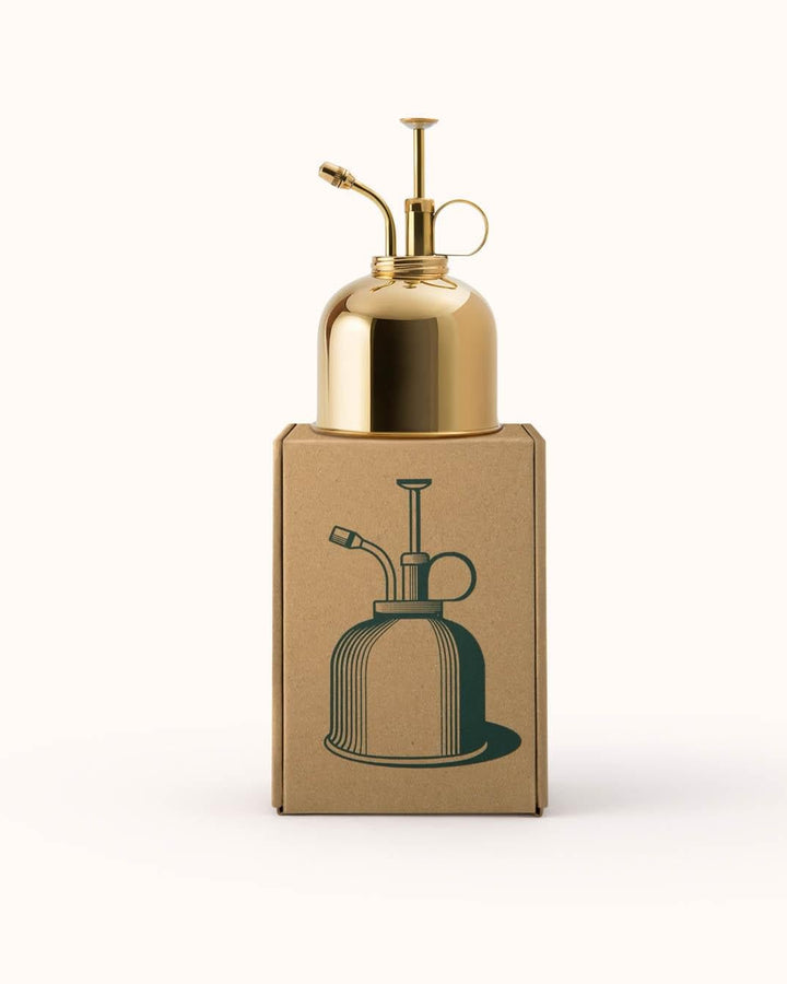 Gold-colored oil dispenser on a white background