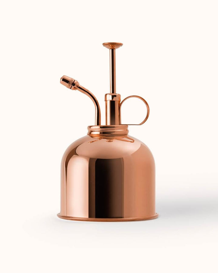 Copper spray bottle on a white background