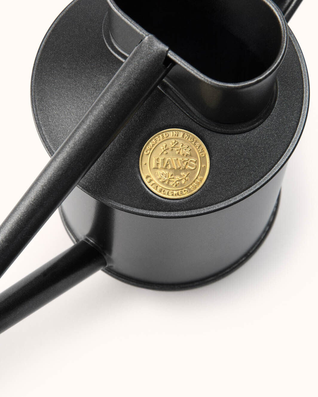 Black lampshade with a gold emblem on a white background