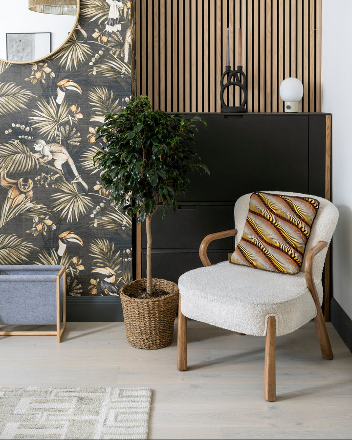 Modern interior with a chair, plant, and decorative wall.